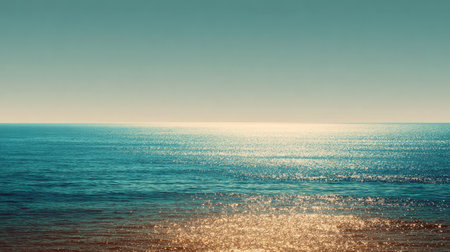 A stunning view of the calm ocean water reflecting sunlight under a clear blue sky creates a serene and tranquil atmosphere, perfect for relaxation.の素材
