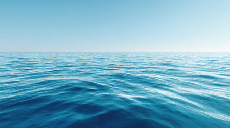 A stunning view of a calm blue ocean under a clear sky, showcasing gentle waves and a serene atmosphere perfect for tranquil moments and nature themes.の素材