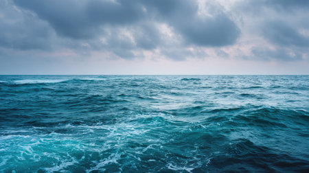 A breathtaking seascape captured at dusk, featuring gentle waves under a dramatic cloudy sky. Ideal for evoking feelings of serenity and nature's beauty.の素材