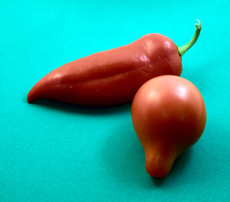 tomatoes, peppers and beans are lying on an old wooden tableの写真素材