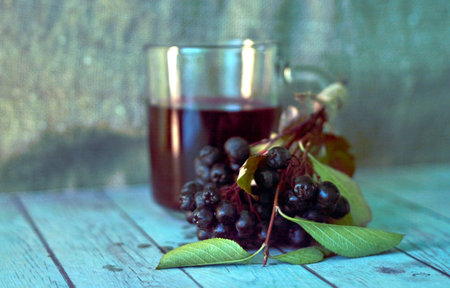 a glass mug with rowan compote and rowan berries are located nearbyの写真素材