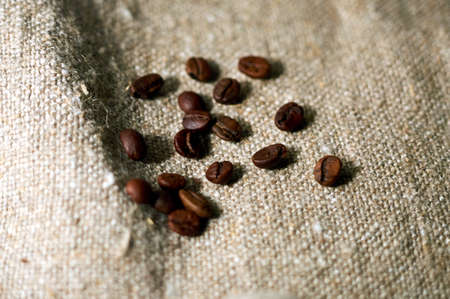 freshly roasted coffee is scattered on burlapの写真素材