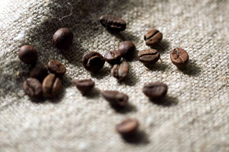 freshly roasted coffee is scattered on burlapの写真素材