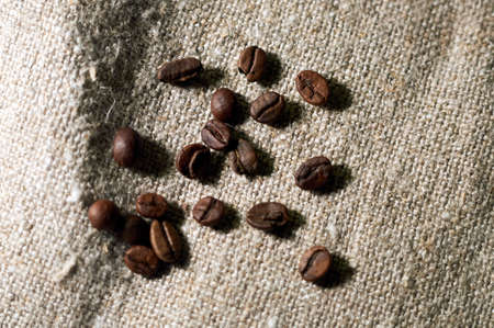 freshly roasted coffee is scattered on burlapの写真素材