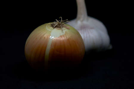 onion and garlic on a black backgroundの写真素材