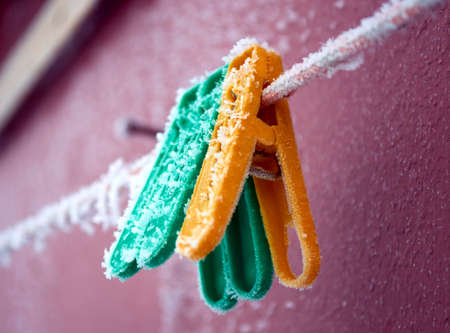 frost on clothespins in the early winter morningの写真素材