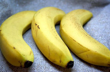 fresh bananas lie on a bag of hard threadsの写真素材