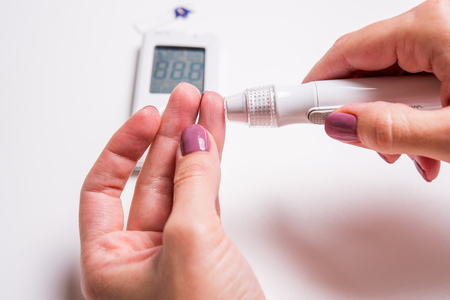 
Measurement of glucose level at home by a personal glucometer, diagnosis of diabetes mellitusの写真素材
