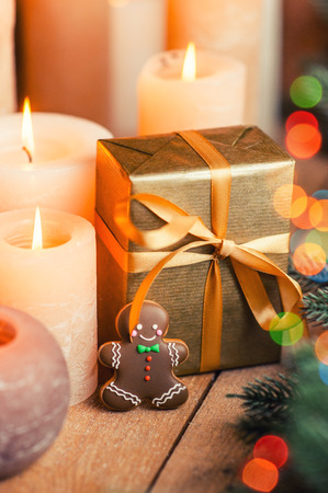 Christmas gifts, candles and  lights under Christmas tree, Christmas cardの写真素材