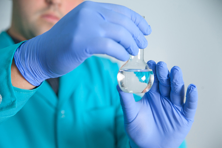 scientist or laboratory technician working with dispenser, a centrifuge, test tubes and other laboratory instrumentsの写真素材
