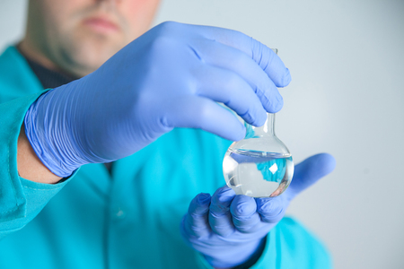 scientist or laboratory technician working with dispenser, a centrifuge, test tubes and other laboratory instrumentsの写真素材