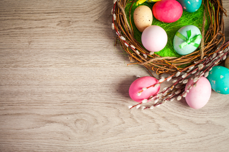 The composition of tulips of different colors on a wooden background, greeting card with free place for inscriptions on Easter or any holidayの写真素材