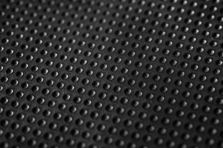 Black dotted texturised technological seamless fabric or surface closeupの写真素材