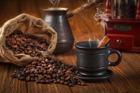 Coffee composition, coffee with coffee grinder, cup and teapot close up