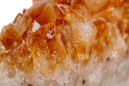 Macro mineral stone Citrine in rock in crystals on a white background close up