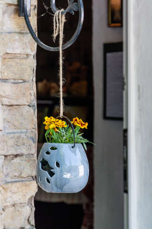 Pendant pots with flowers and greens close upの写真素材