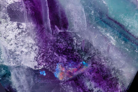 Macro mineral stone Fluorite crystal on a black background close-up