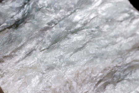Macro mineral stone Talc on black background close up