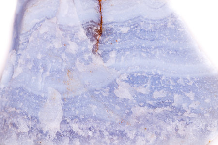 Macro mineral blue agate in the rock on white background close up