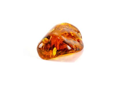 Macro Amber mineral stone with spider on white background close up
