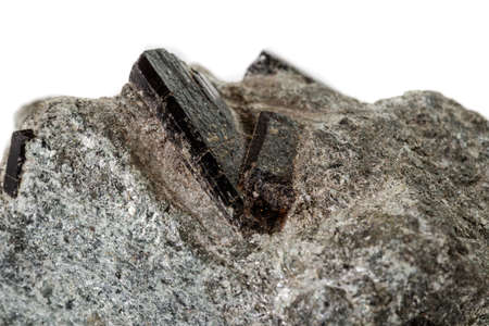 macro mineral stone schorl, black tourmaline on white background close up