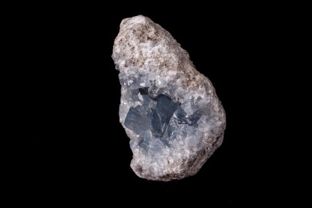 Celestine mineral stone macro on microcline on black background close up
