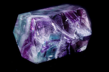 Macro mineral stone Fluorite crystal on a black background close-up