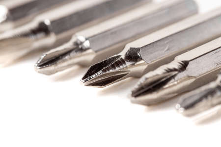 A set of different attachments for a head screwdriver with a screwdriver on a white background...