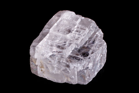 Macro mineral stone Iceland spar on black background close up