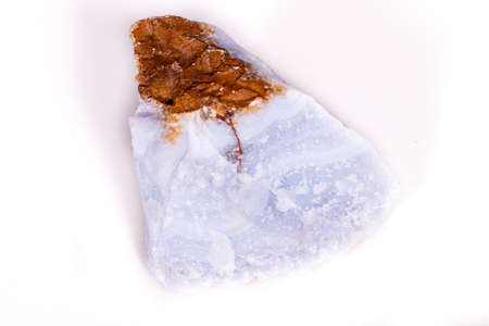 Macro mineral blue agate in the rock on white background close up