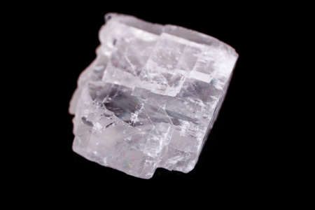 Macro mineral stone Iceland spar on black background close up