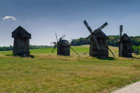 Old windmill on blue sky background close up