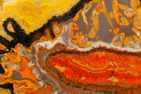 Macro mineral stone Bee jasper on a gray background close-up