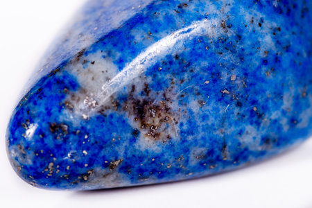 Macro mineral stone blue lapis lazuli (afghanistan) on white background close up
