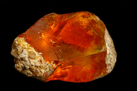 Macro Opal mineral stone in rock on black background close up