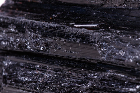 macro mineral stone sherle, schorl, black tourmaline on white background close-upの写真素材