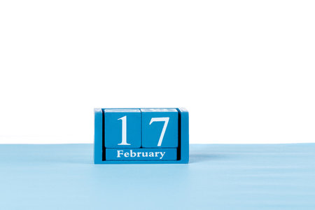 Wooden calendar February 17 on a white background close upの写真素材