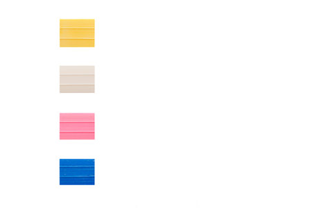 chalk for fabric, sewing, white, pink, blue, yellow on a white background close-up