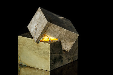 Macro mineral stone Pyrite on a black background close up