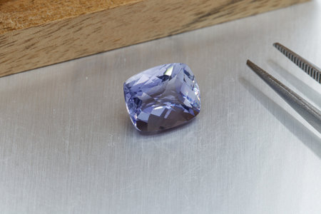 macro mineral faceted stone Cordierite on a gray background close-upの写真素材