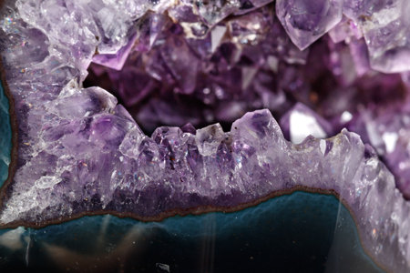 Macro Mineral Stone Amethysts in the rock on a white background close up