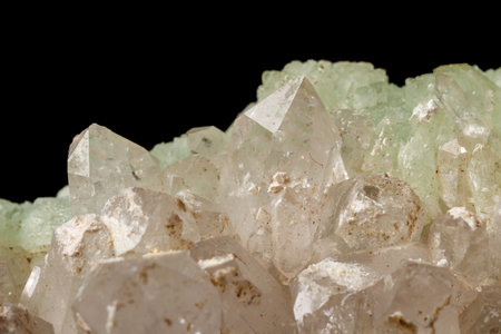 Macro mineral stone Prehnite quartz on a black background close up