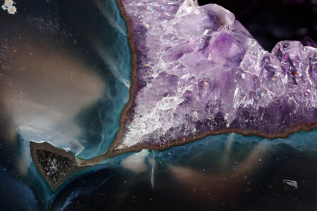 Macro Mineral Stone Amethysts in the rock on a white background close up