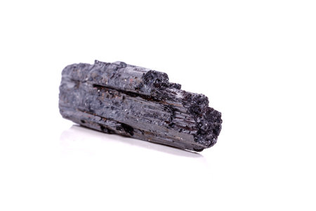 macro mineral stone sherle, schorl, black tourmaline on white background close-up