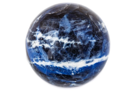 Macro mineral stone Sodalite ball on white background close up