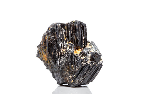 macro mineral stone sherle, schorl, black tourmaline on white background close-upの写真素材