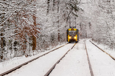 An old tram moving through a winter forest close upの写真素材