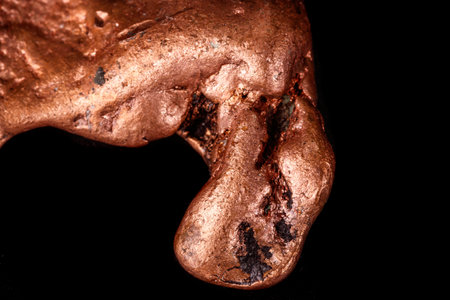 Macro mineral stone of a copper nugget on a microcline on a black background close upの写真素材