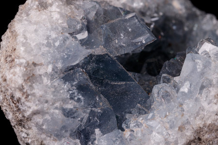 Celestine mineral stone macro on microcline on black background close up