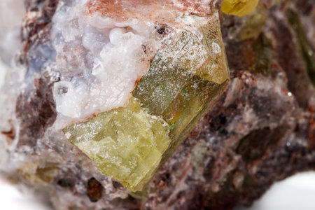 Macro mineral stone Golden Apatite on a white background close up